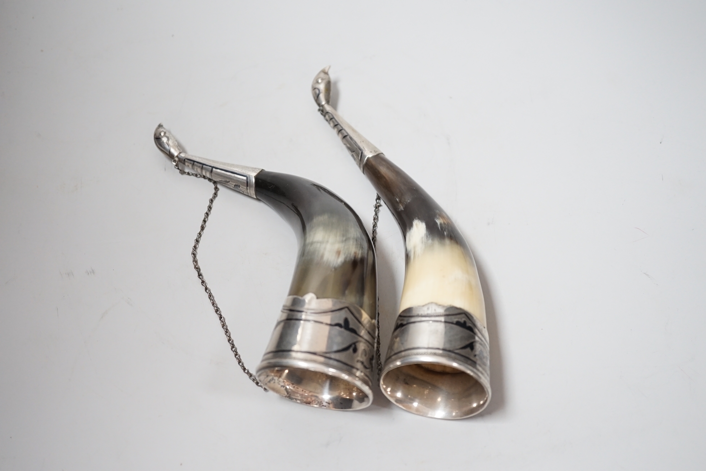 A pair of mid 20th century Soviet Union 875 white metal and niello mounted drinking horns, approx. 25cm.